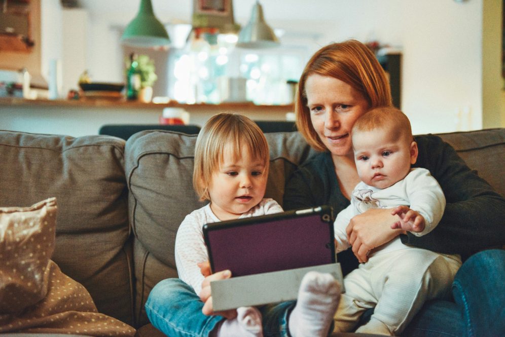 family playing on tablet together