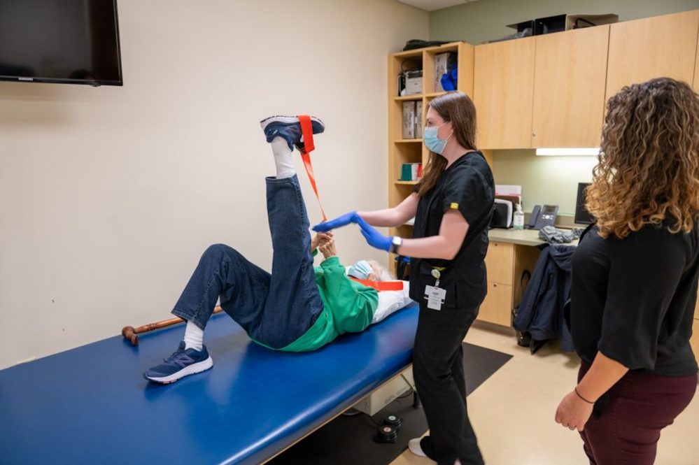 Evelyn Reuter performs exercises as part of a UConn Center on Aging Study under the supervision of research associate Kylie Baker (center) and Jenna Bartley Ph.D (right). (Tina Encarnacion/UConn Health photo)